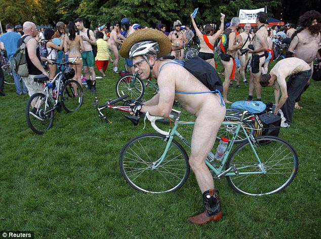 Legal: Cyclists prepare to pour into the streets of Portland for the 11th annual World Naked Bike Ride June 7. While the event could be considered criminal in many places, the city of Portland works with the celebrants to keep things legit