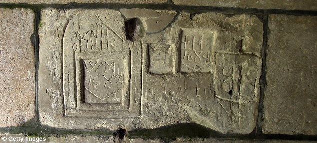 Historic: Old graffiti is seen on the walls of St Giles Church