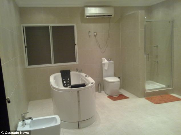 Luxurious: The bathroom in Mayomi's Nigerian mansion was fitted with a free-standing bathtub