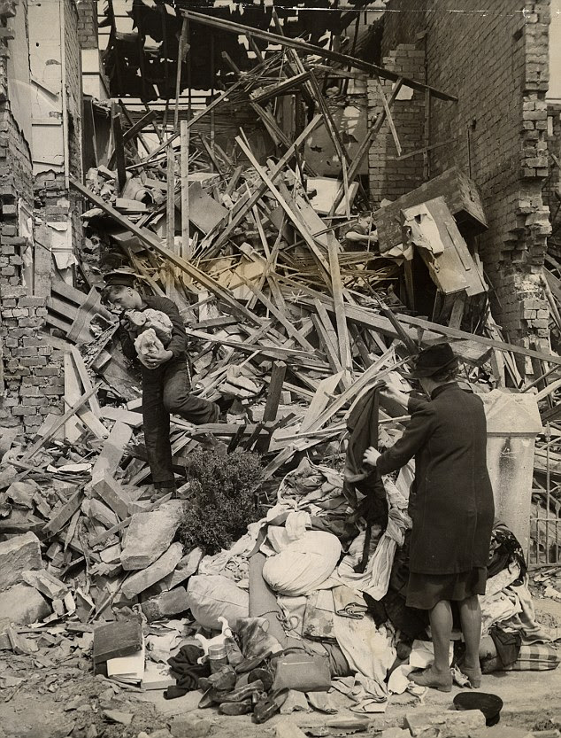 Fragments: A sailor lends a hand in recovering belongings from a house in Bath during the Baedeker Blitz 