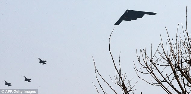 'Deterrence': A B-2 stealth bomber (right) soars through the sky over a U.S. air base in Pyeongtaek, South Korea, amid rising tension between the country and its neighbour the North
