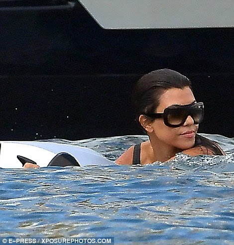 Always stylish: Kourtney kept her oversized sunglasses on as they frolicked in the water