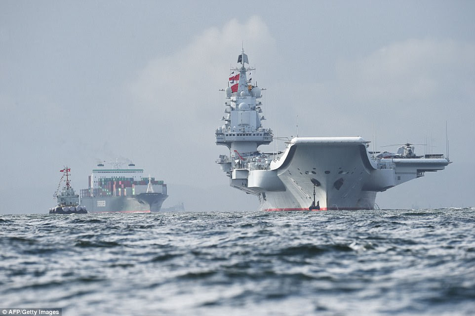 Anchoring off Lantau island in the harbour's outer reaches, the carrier was flanked by a protective cordon of marine police craft and a locally-based Chinese navy corvette