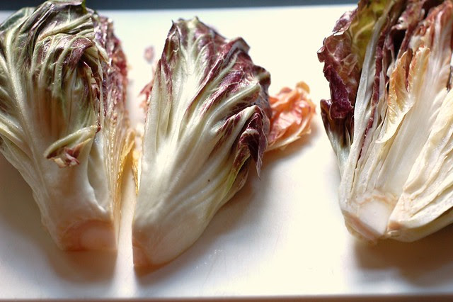 Tossing the quartered radicchio with olive oil, salt and pepper by Eve Fox, Garden of Eating blog, copyright 2012