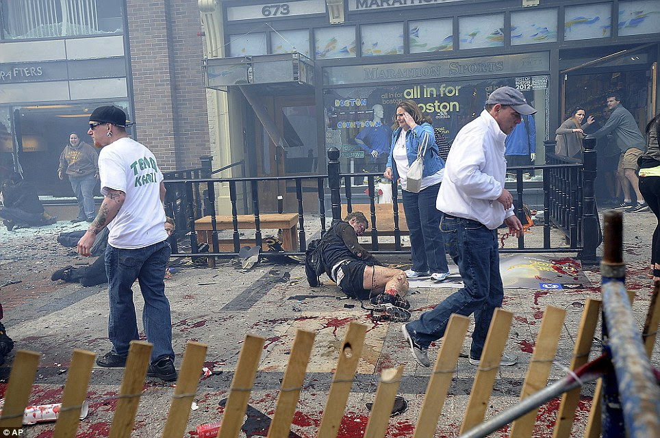 Carnage: Injured people and debris lie on the sidewalk near the Boston Marathon finish line 