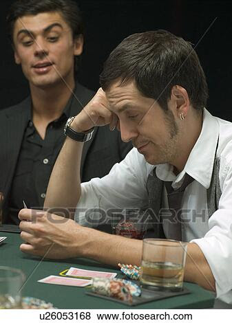Person looking at their cards in poker Selection slots of vegas online
