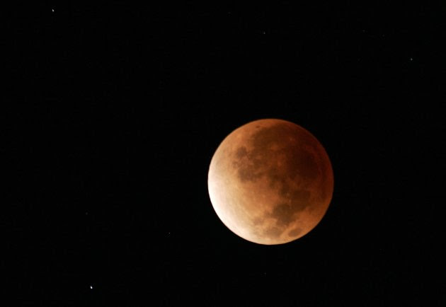 The lunar eclipse sets over the North Shore of Oahu in Haleiwa, Hawaii.