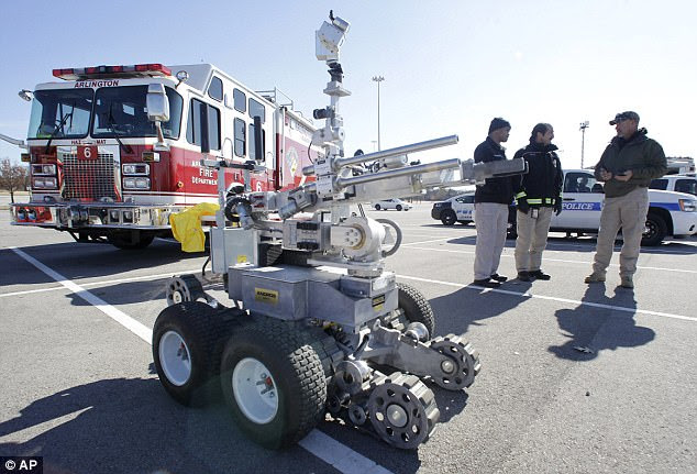 It was not immediately confirmed what kind of device was used in Dallas, Texas. Here, Arlington Fire Department officials stand by a robot bomb vehicle made by Northrop Grumman, a standard model for police and military use and one of three at the department's disposal