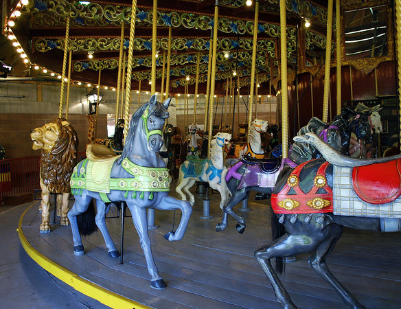 This antique carousel is one of the largest and best remaining examples of a Looff menagerie carousel that is four rows deep with  69 carousel animals including jumpers, standers and a gigantic lion, goats (prancers), giraffes, and camels.