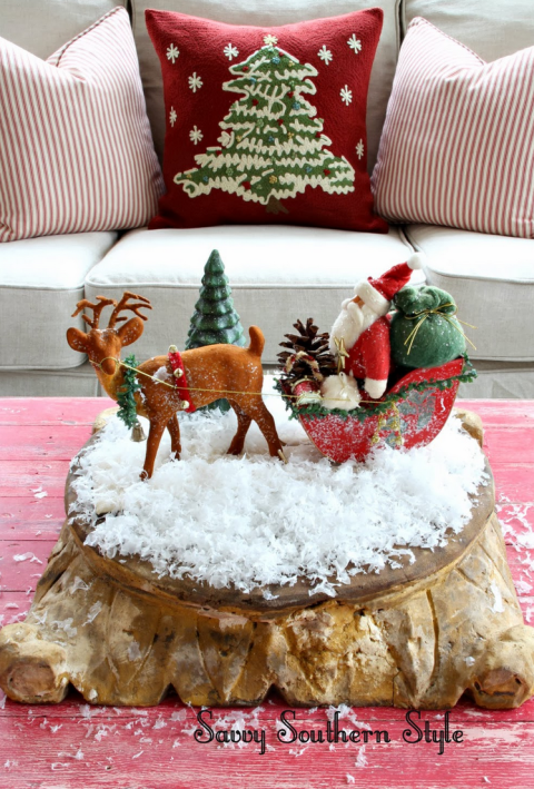 A miniature display of Santa Claus and his reindeer looks especially fun on some fake snow. 
See more at Savvy Southern Style »
