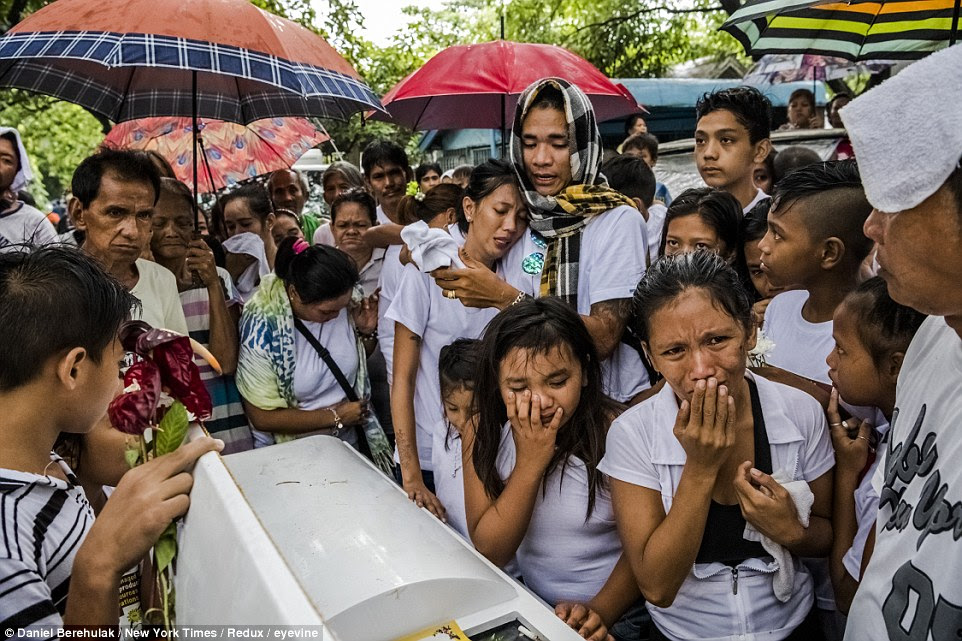  Family and friends attend the funeral of Joselito Jumaquio, who was slain by a mob of masked men, in Manila, Philippines