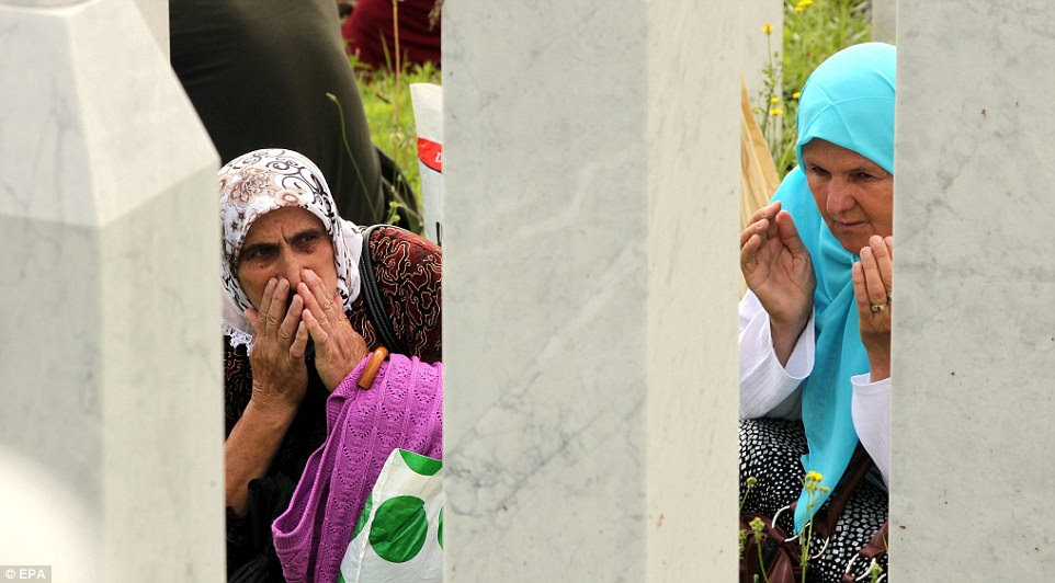 epa04310610 Bosnian Muslim women pray at the Potocari Memorial Center during the funeral in Srebrenica, Bosnia and Herzegovina, 11 July 2014, where 175 newly-identified Bosnian Muslims were buried. The burial was part of a memorial ceremony to mark the 19th anniversary of the Srebrenica massacre, considered the worst atrocity of Bosnia's 1992-95 war. More than 8,000 Muslim men and boys were executed in the 1995 killing spree after Bosnian Serb forces overran the town.  EPA/FEHIIM DEMIR