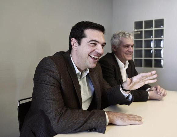 Alexis Tsipras (L), opposition leader and head of radical leftist Syriza party, smiles during a meeting with members of the Greens-Ecologists party, at the party's headquarters in Athens January 7, 2015. REUTERS/Alkis Konstantinidis