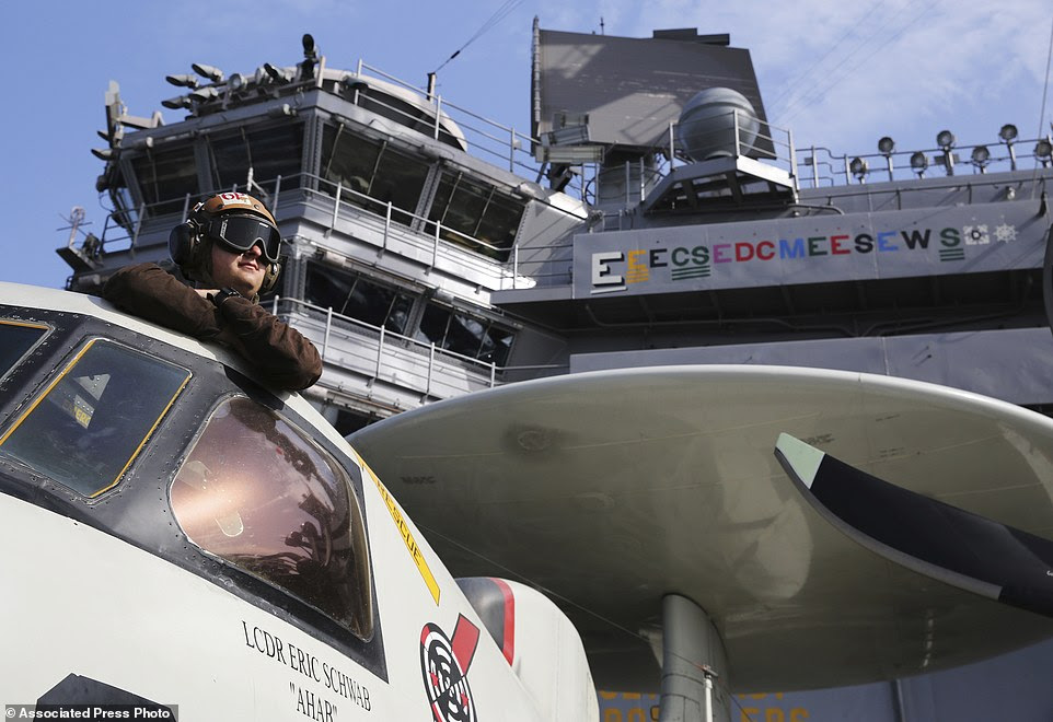 The pilot of an E-2C Hawkeye watches flight operations on the USS George H.W. Bush. Its passage through the strait closes a roughly three-month gap in which America had no aircraft carrier in the Persian Gulf