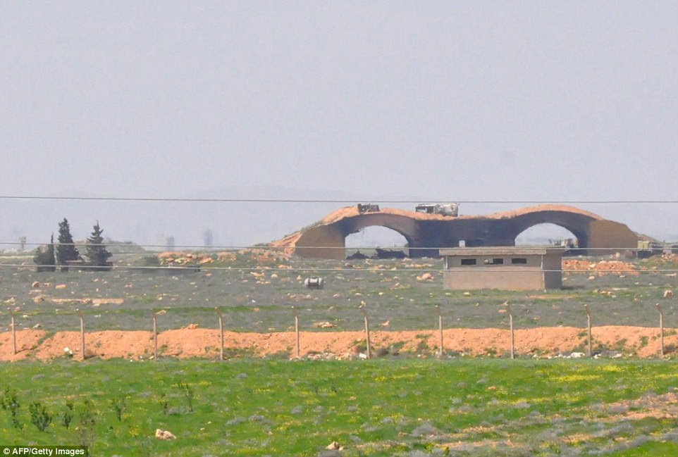 First picture: These damaged hangars, blackened by smoke, are at the entrance to the Syrian airfield bombarded by the US