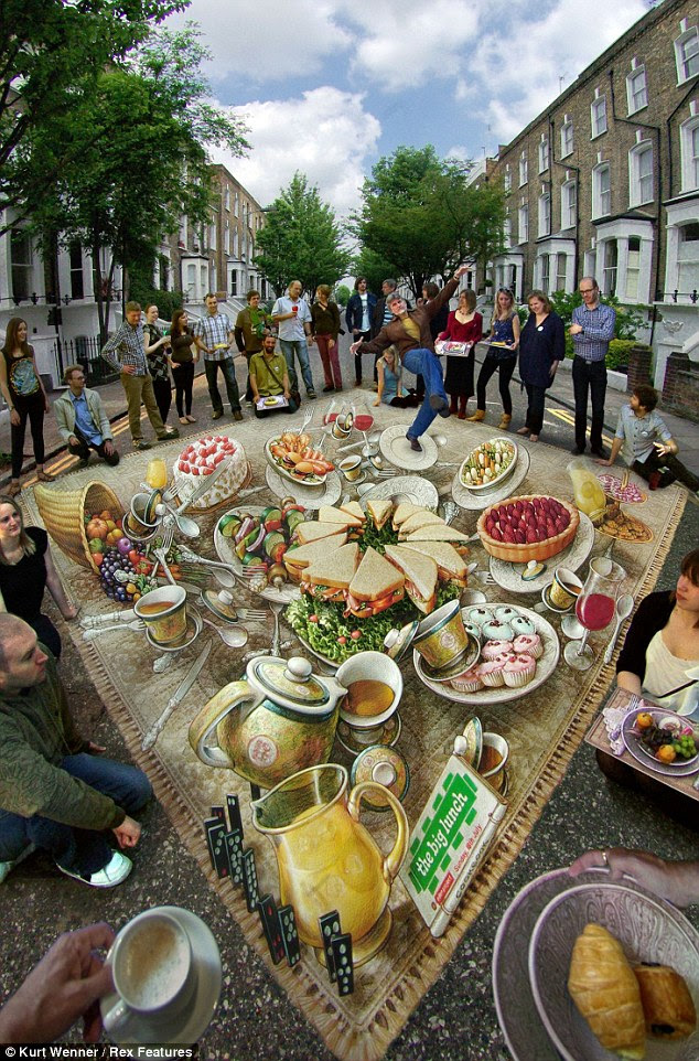 Street party: Islington residents are treated to a giant picnic complete with sandwiches and cakes courtesy of Wenner