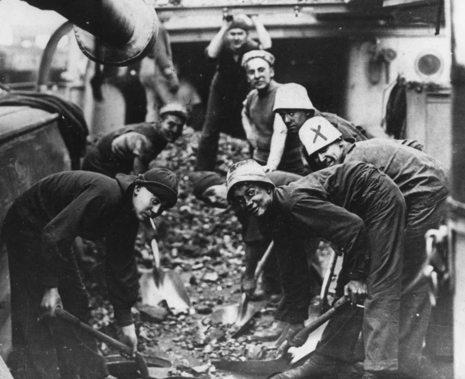 Sailors on board USS Isla de Luzon shovel coal in the early 1900s. Naval History and Heritage Command Photo