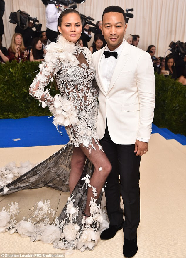 Heavenly: Mais cedo, John chegou com sua outra metade impressionante Chrissy Teigen que aturdido em um vestido mini Marchesa branca pura que mostrou sua midsection tonificada e pernas longas