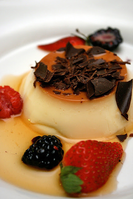 Quesillo: Venezuelan caramel flan served with fresh berries