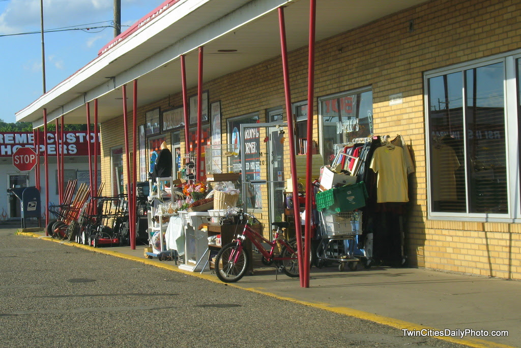 What happens when you have a hardware store next to a thrift store, with both store have items for sale sitting out on the sidewalk....well, it looks like a bunch of junk from this angle. I'm sort of laughing at the photo because there are actually three store entrance doors among all of the goods for sale.