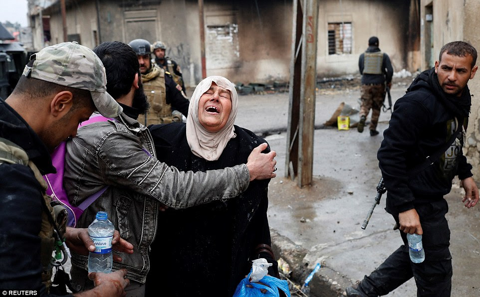 A woman bursts into tears after crossing from an ISIS-held district of west Mosul into an area liberated by the Iraqi Army 