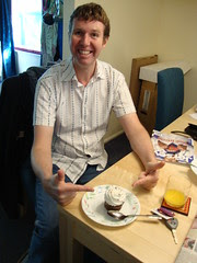 Pete and a cupcake (and massive amounts of cardboard around him)