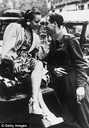 Hero's welcome: An RAF officer and a flirtatious young Parisian. Paris welcomed officers with open arms and open beds after their triumph