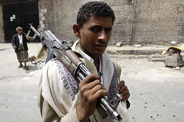 A Yemeni armed anti-government protester holds his gun in the Al Hasba neighborhood of Sanaa on September 29, 2011. Heavy clashes rocked northern neighborhoods of Yemen's capital. by Pan-African News Wire File Photos