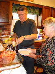 Mom and Swami carve the ham