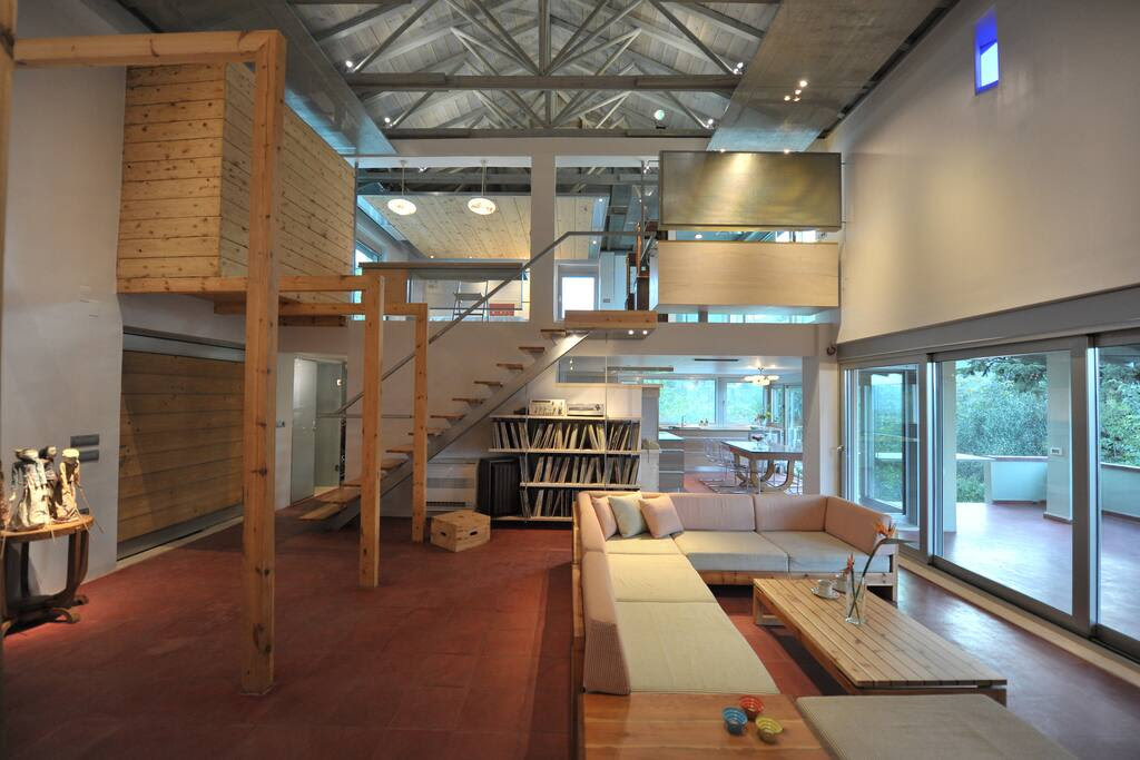 The living room in the front, the entrance on the left, the main bedroom on the top floor, the kitchen in the back on the right and the terrace on the right.