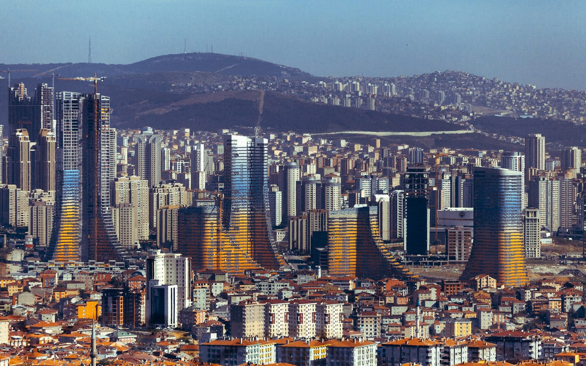 #7 VARYAP MERIDIAN — Istanbul's new Varyap Meridian has 1,500 apartments, a five-star hotel, and office space. The outside of the buildings are terracotta-colored near the ground, and transition into blue glass at the top.