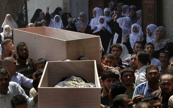 Palestinian mourners carry the coffins o