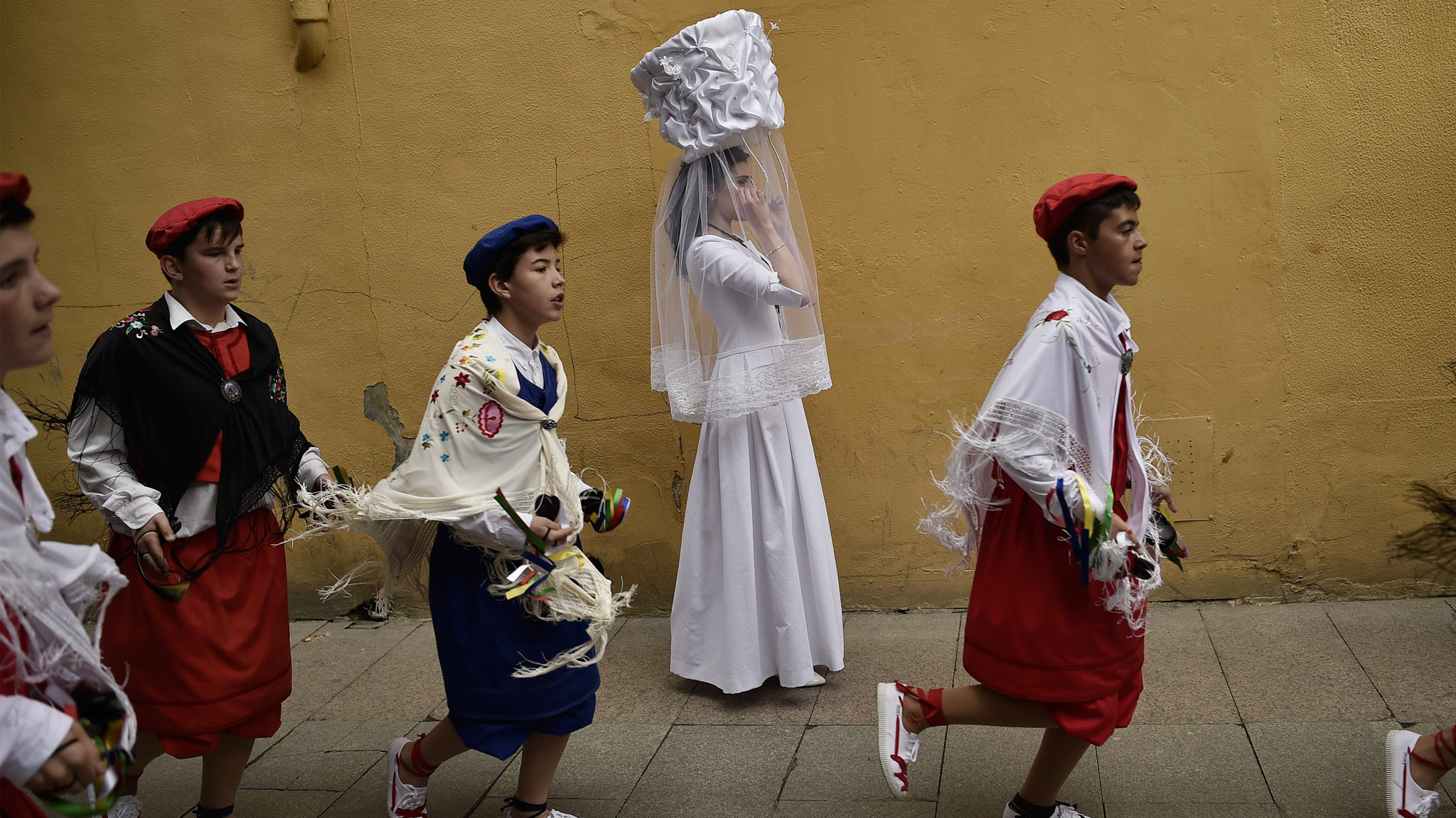 A participant in the ''Bread Procession of the Saint'' takes part in a ceremony in honor of Domingo de La Calzada Saint (1019-1109), in Santo Domingo de La Calzada, northern Spain, Wednesday, May 11, 2016. Every year during spring season, ''Las Doncellas'' (White Virgins), hold a basket on their head covered with white cloth while they walk along this old village in honor of the saint.
