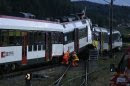 Rescue workers are seen at the site of a head-on collision between two trains near Granges-pres-Marnand, near Payerne
