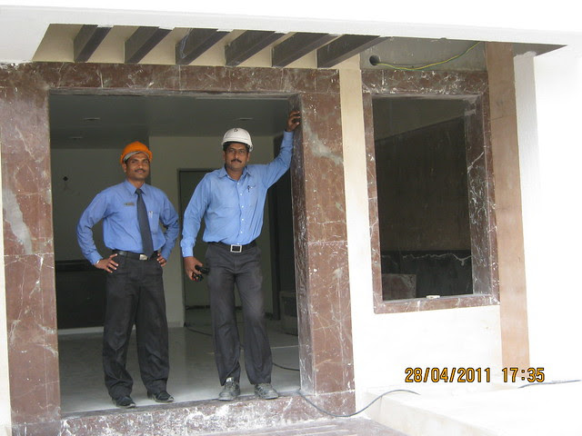 Mr. Dattatraya (Customer Care) with Mr. Dinesh Deulkar (Senior Engineer) in the entrance lobby of the B Tower in Sangria at Megapolis Hinjewadi Phase 3, Pune
