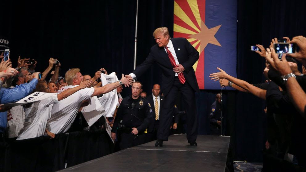 PHOTO: Republican presidential candidate Donald Trump shakes hands as he arrives to speak at a rally before a crowd of 3,500 Saturday, July 11, 2015, in Phoenix.