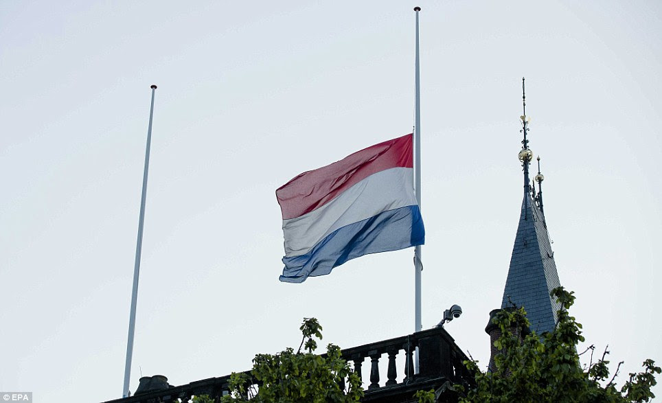 Mourning: The Dutch flag flies at half mast on the parliament building in The Hague. The Dutch government has declared today a day of national mourning for the victims of the MH187 disaster