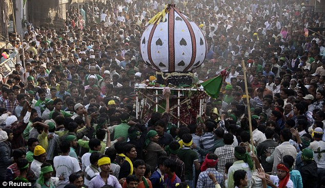 Tribute: Shiite Muslims carry a replica of the coffin of Imam Hussein during a Muharram procession in the northern Indian city of Allahabad 