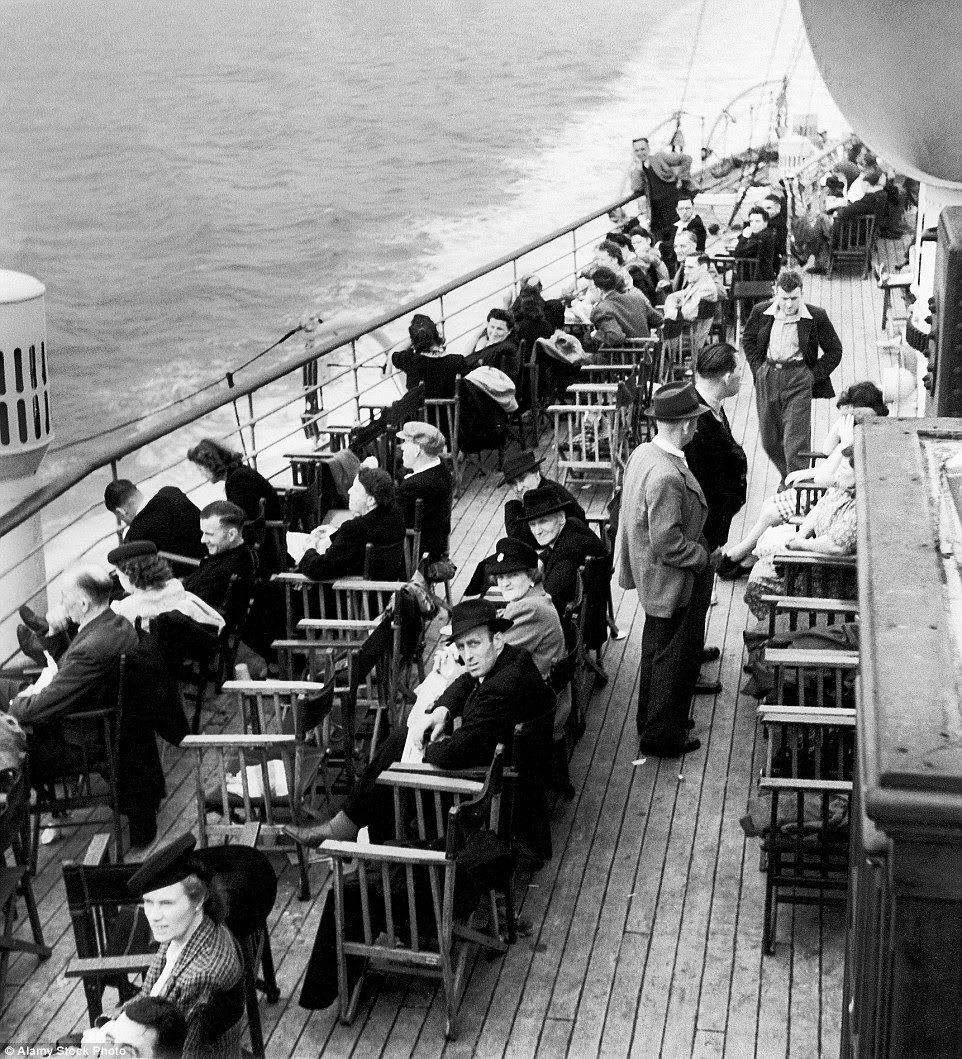 Sea view: Guests take in the vast ocean  as they sit on the deck, circa 1950