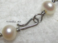 wire wrapped clasp with pearl Close up of wire wrapped clasp with pearl