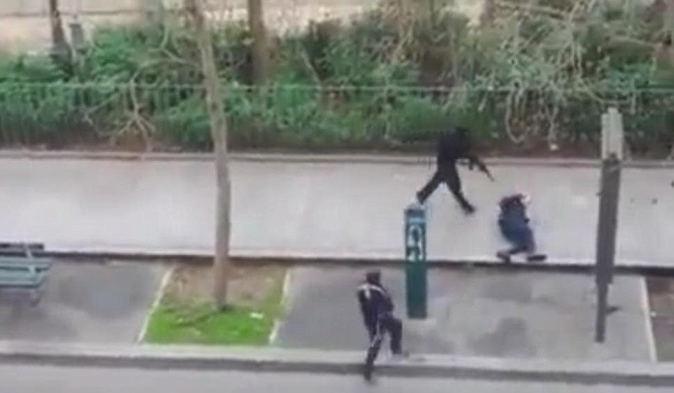 This is an image of a police offering begging for his life at the Charlie Hebdo building.. The media is opting to only show this still image and now the next scene in which the officer has his head blown off..