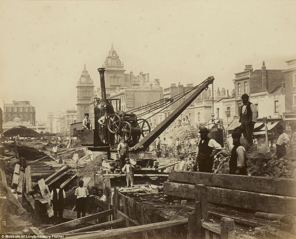 Break in proceedings: A group of railway construction workers, or 'navvies', pose for the camera beside a steam crane in Praed Street, Paddington