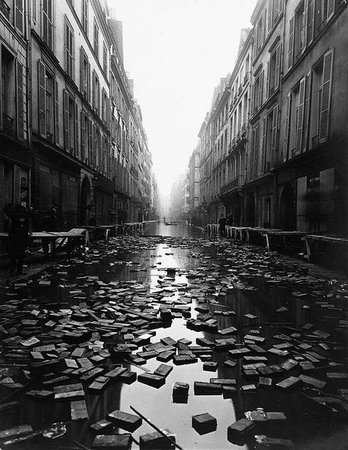 Library books floating down a street during the Great Flood of Paris, 1910.