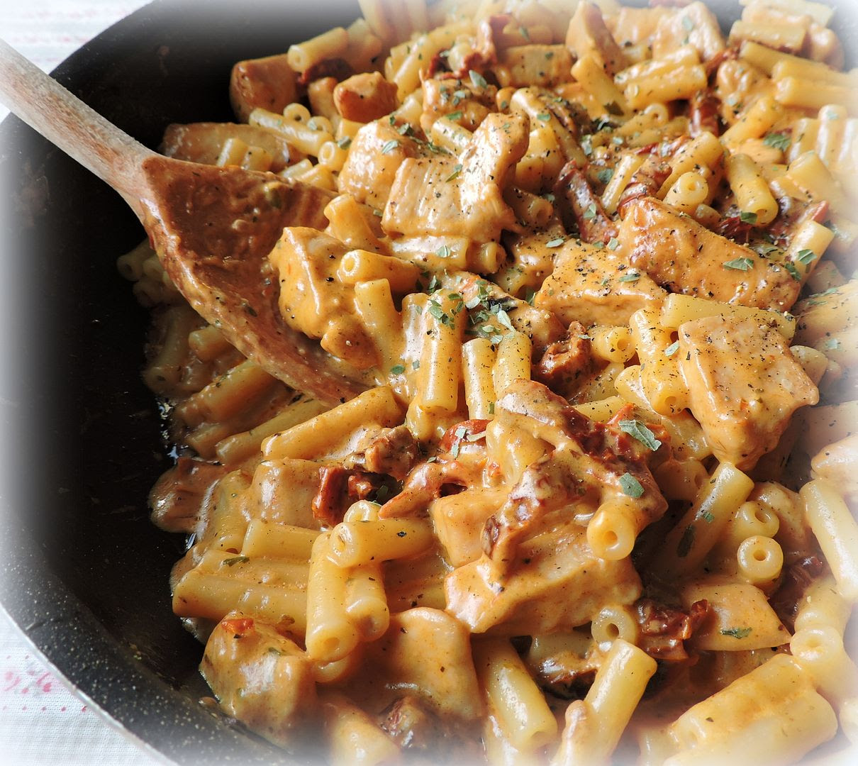 Chicken and Pasta in a Garlic and Tomato Cream Sauce. Chicken and Pasta in a Garlic and Tomato Cream Sauce.