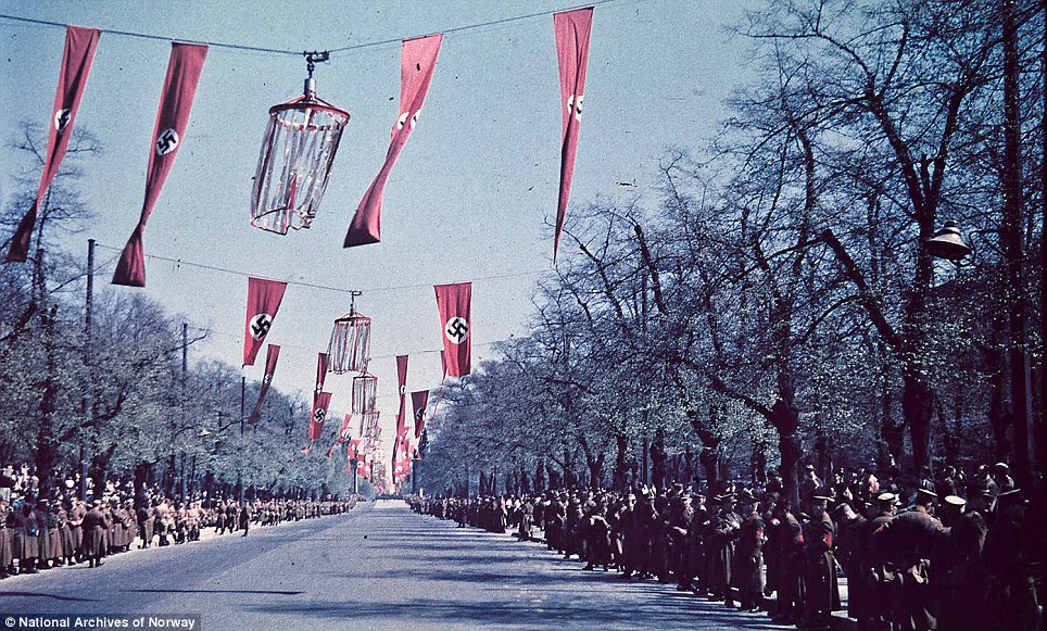 Order: This intimidating picture shows troops lining a boulevard festooned with swastikas in anticipation of a parade