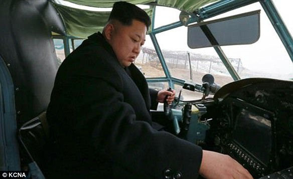 Kim Jong-un, pictured at the controls of one of the ancient aircraft was observing drills involving his elite paratroops who jumped out of the aircraft during a training mission 