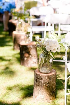 Vintage outdoor wedding isle decorations.... The logs and Jars of flowers.... Darling idea! Then you could place them around afterwards!