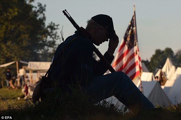 Moment of silence: A re-enactor portraying a Union soldier sits at camp during a quiet moment before battle