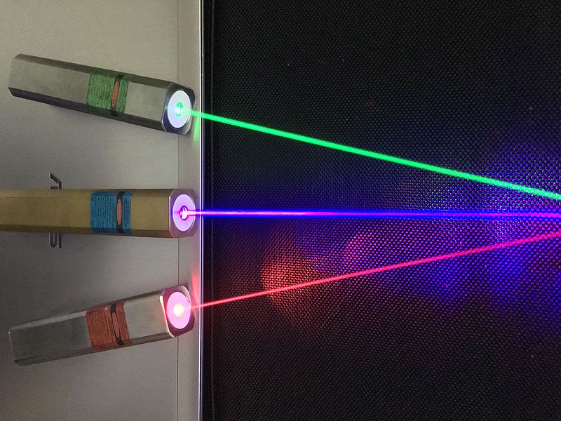 A picture of three differently coloured laser pointers