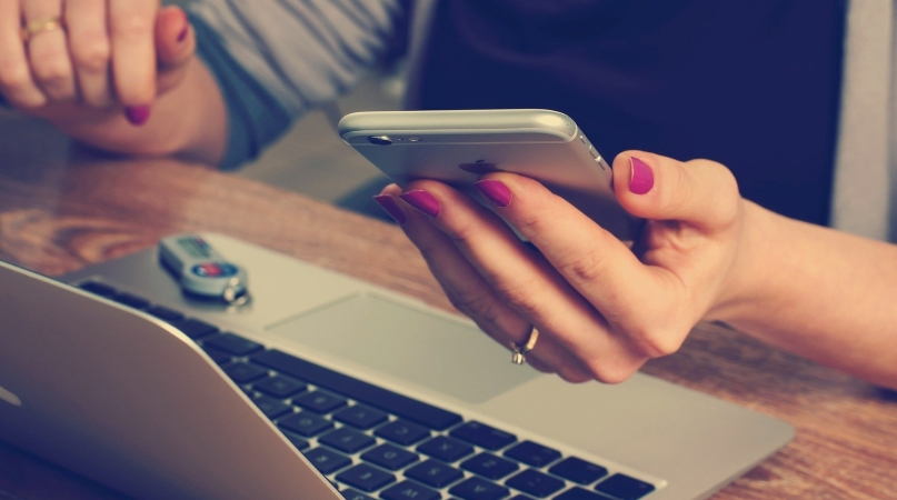 woman working on her laptop and phone